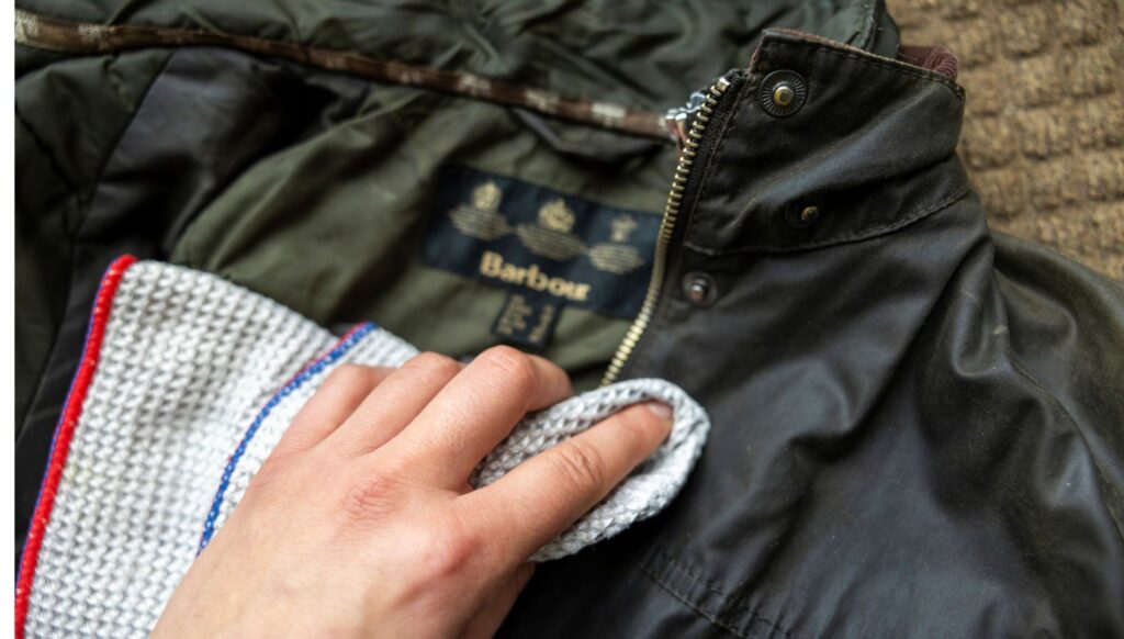 Hand inspecting a waxed jacket before re-waxing